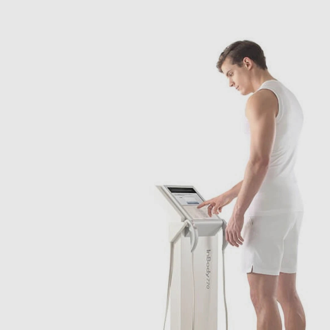 Person using a Inbody 770 machine on a white background