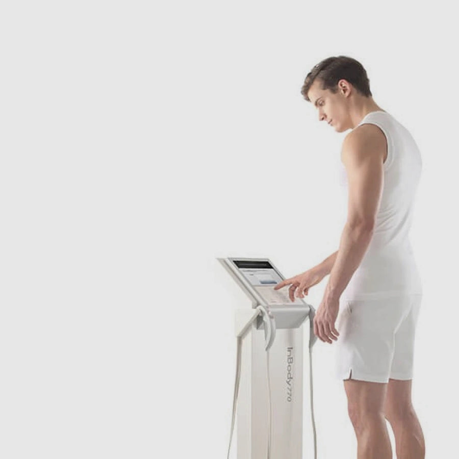 Person using a Inbody 770 machine on a white background